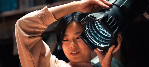 Young person holding up a theatre light