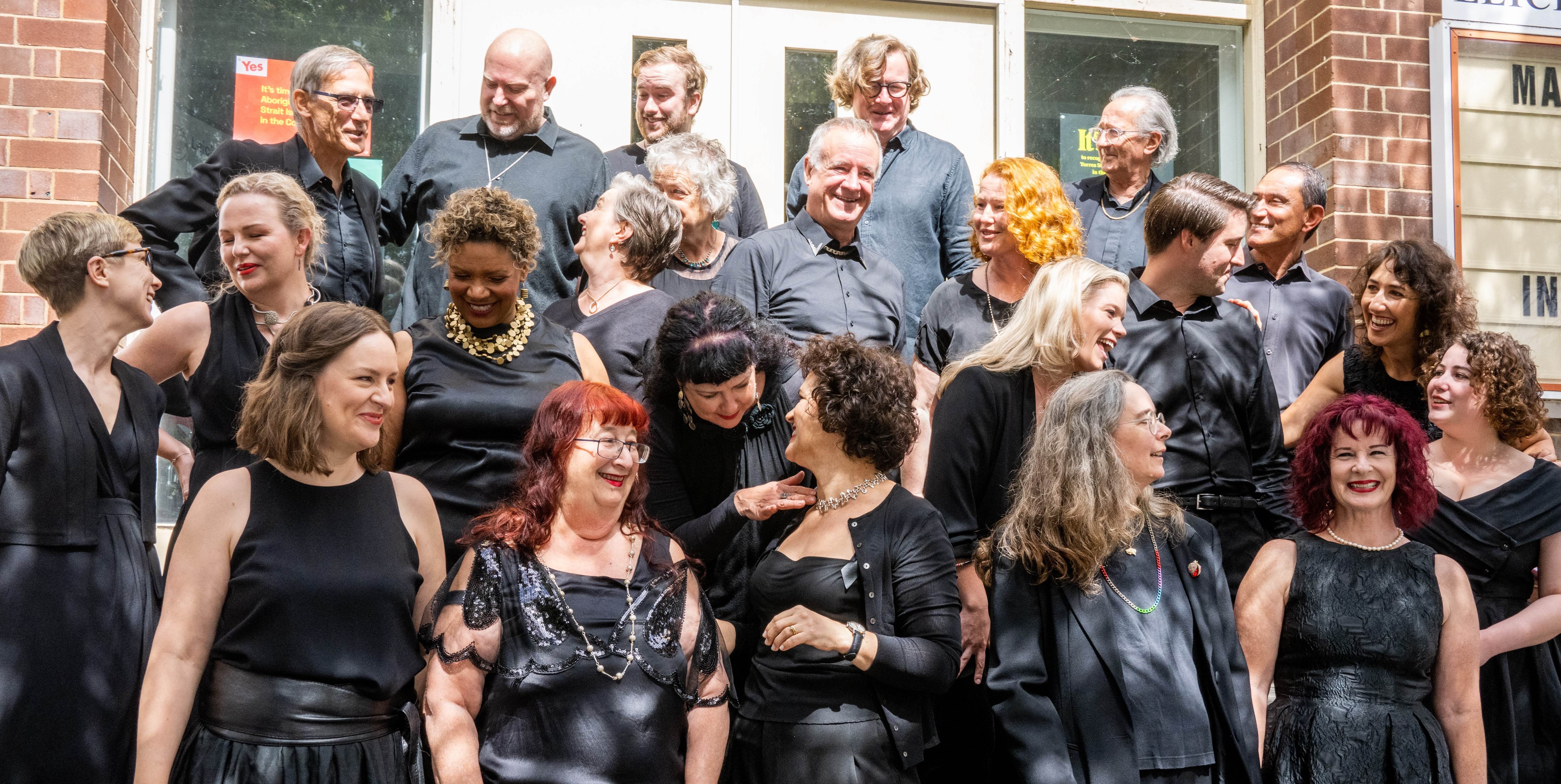 Choir members standing on the steps of a church