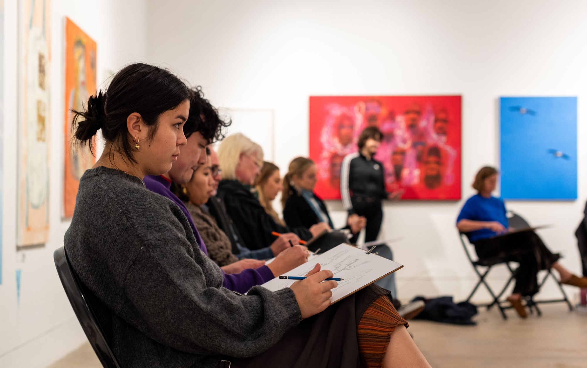 People taking part in a life drawing class