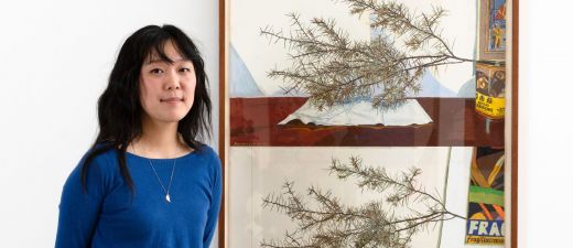 An image of a Rosemary Lee standing in front of her winning artwork.