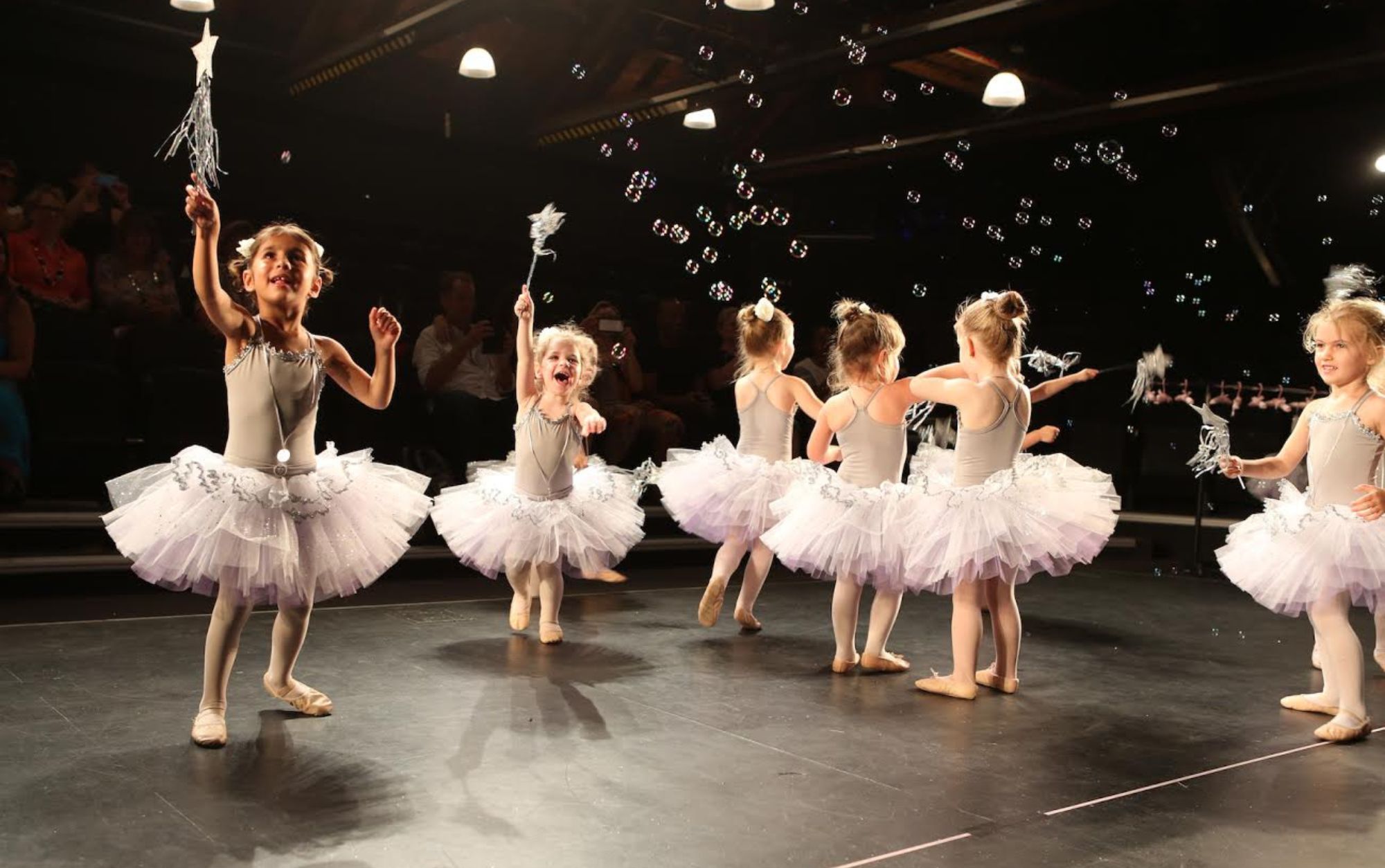 Small ballerinas dancing on stage