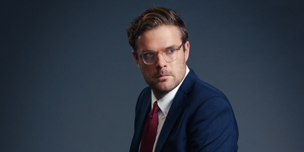 Guys Williams side profile with blue background