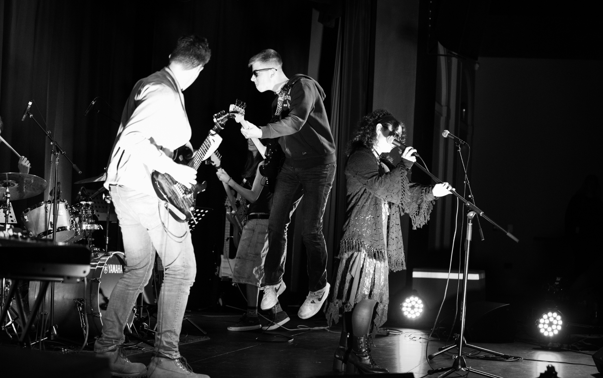 Band on stage hi energy and jumping