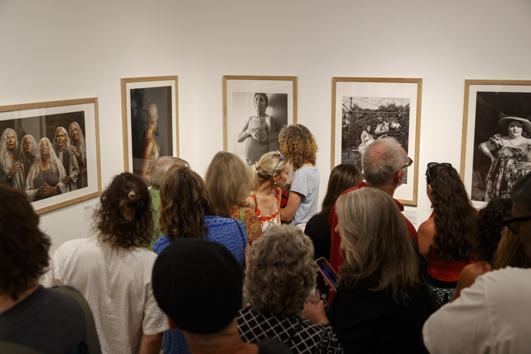 People viewing the Head On Portrait Awards at Bondi Pavilion Gallery.