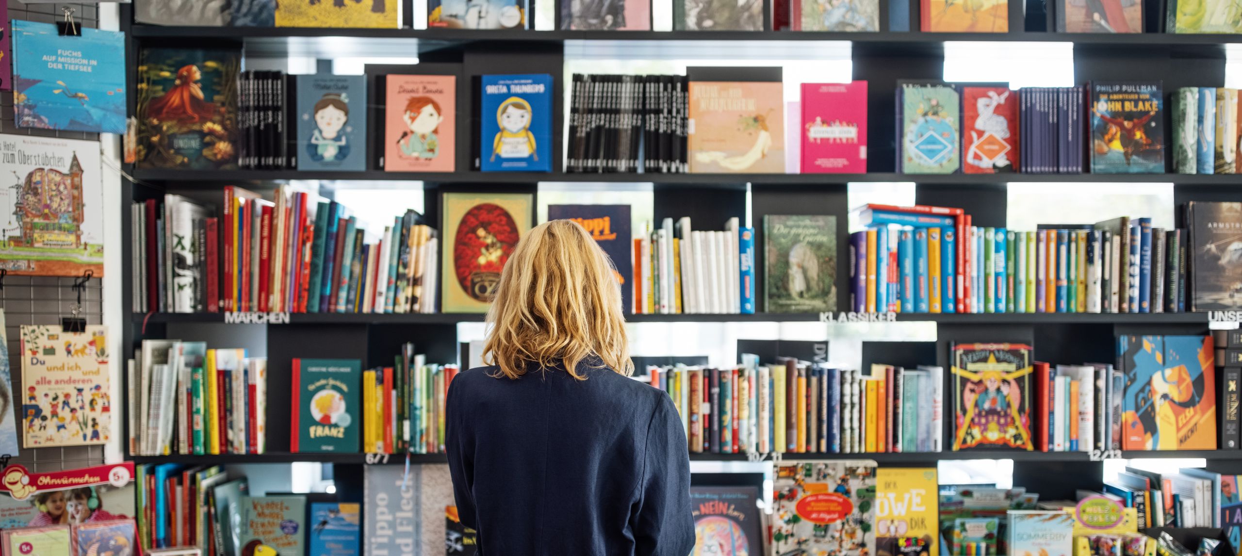 Woman reading books in a book store