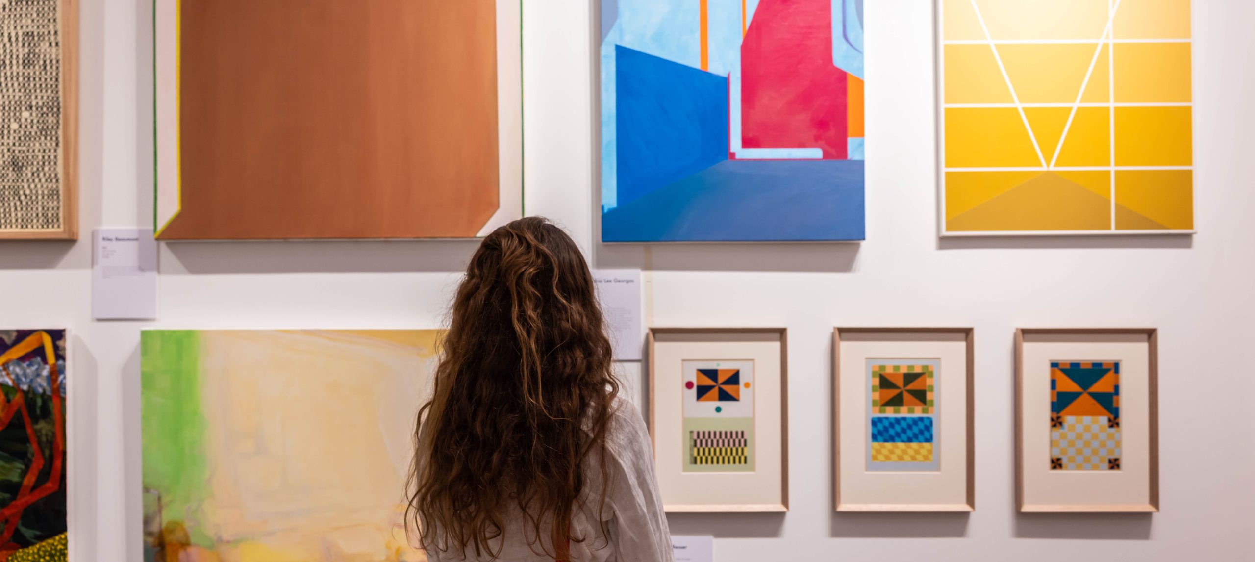 woman in front of a painting