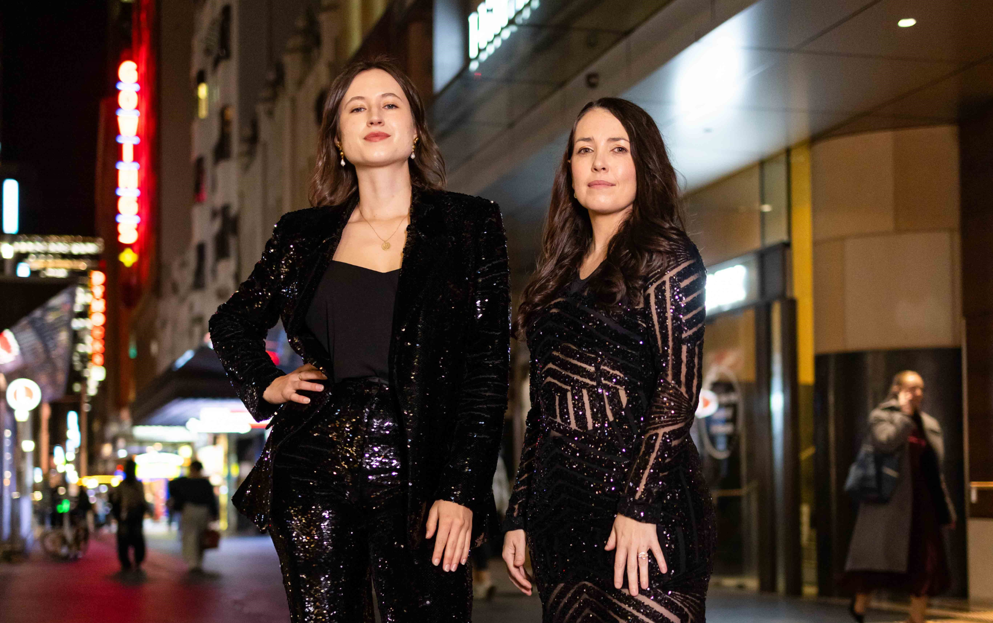 Two female musicians in the street at night