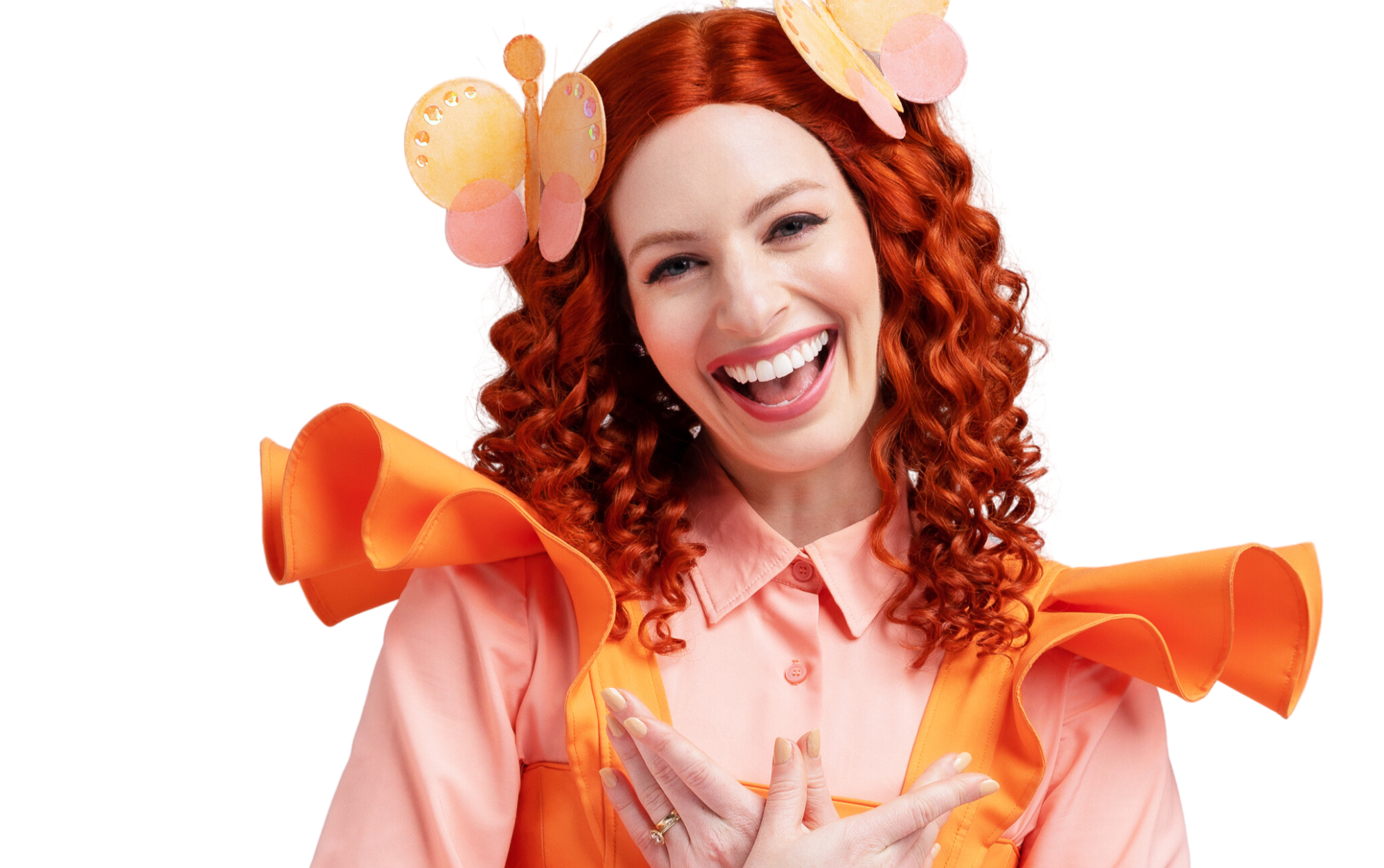 A young lady with bright red hair, butterfly clips and a warm friendly smile