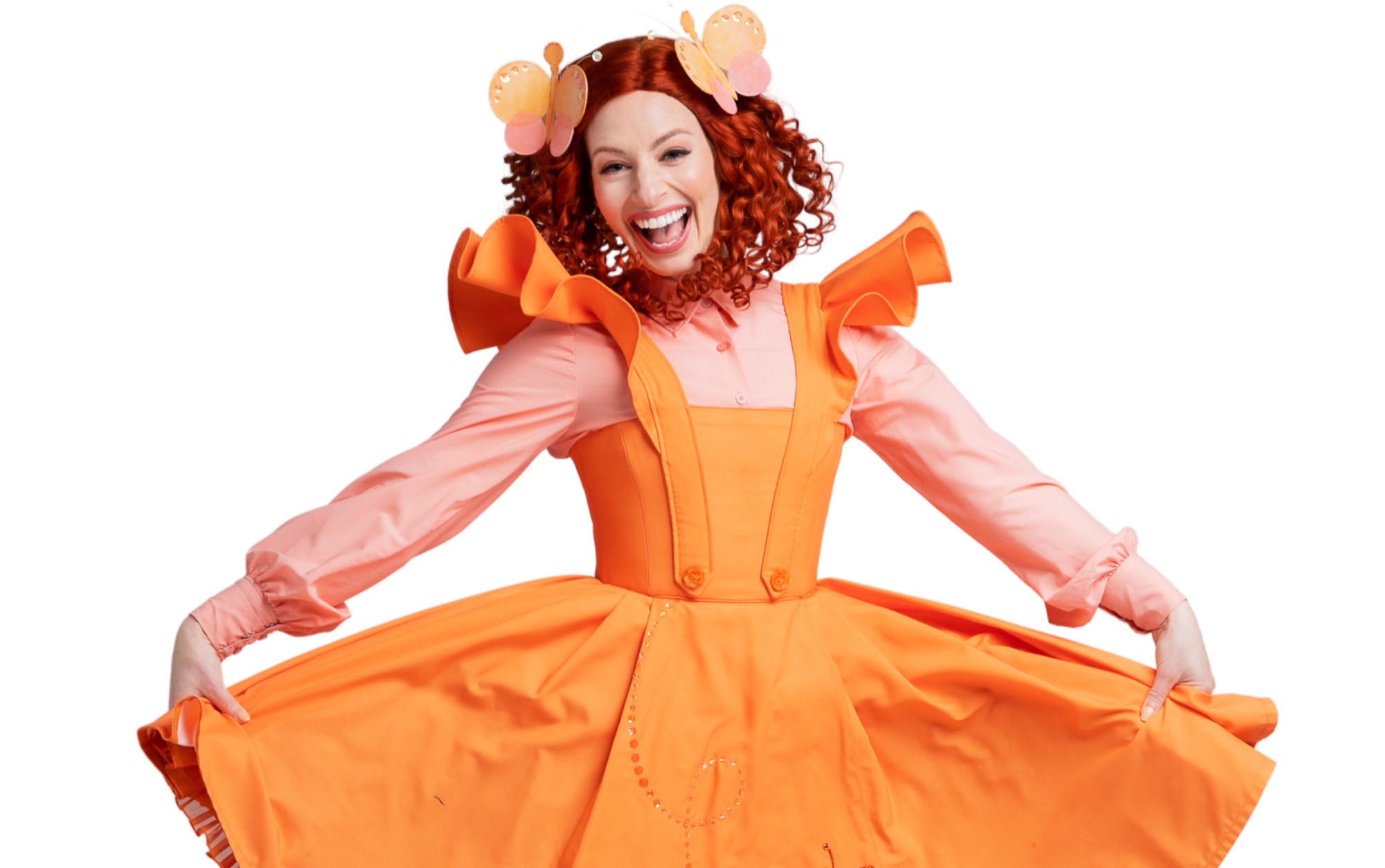 A woman with red hair, butterfly clips and a big warm smile dancing