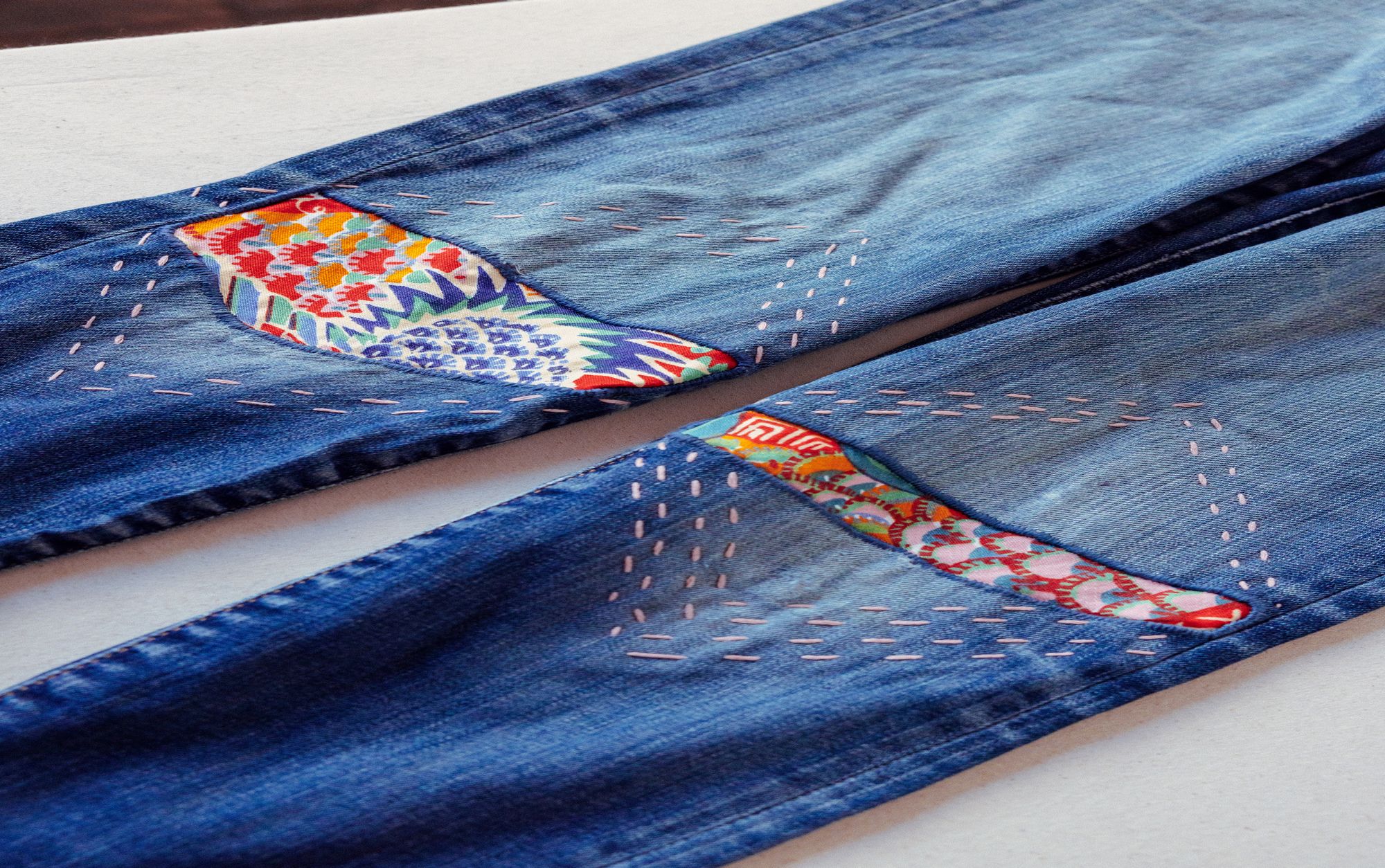 Jeans stitched with colourful fabric pattern