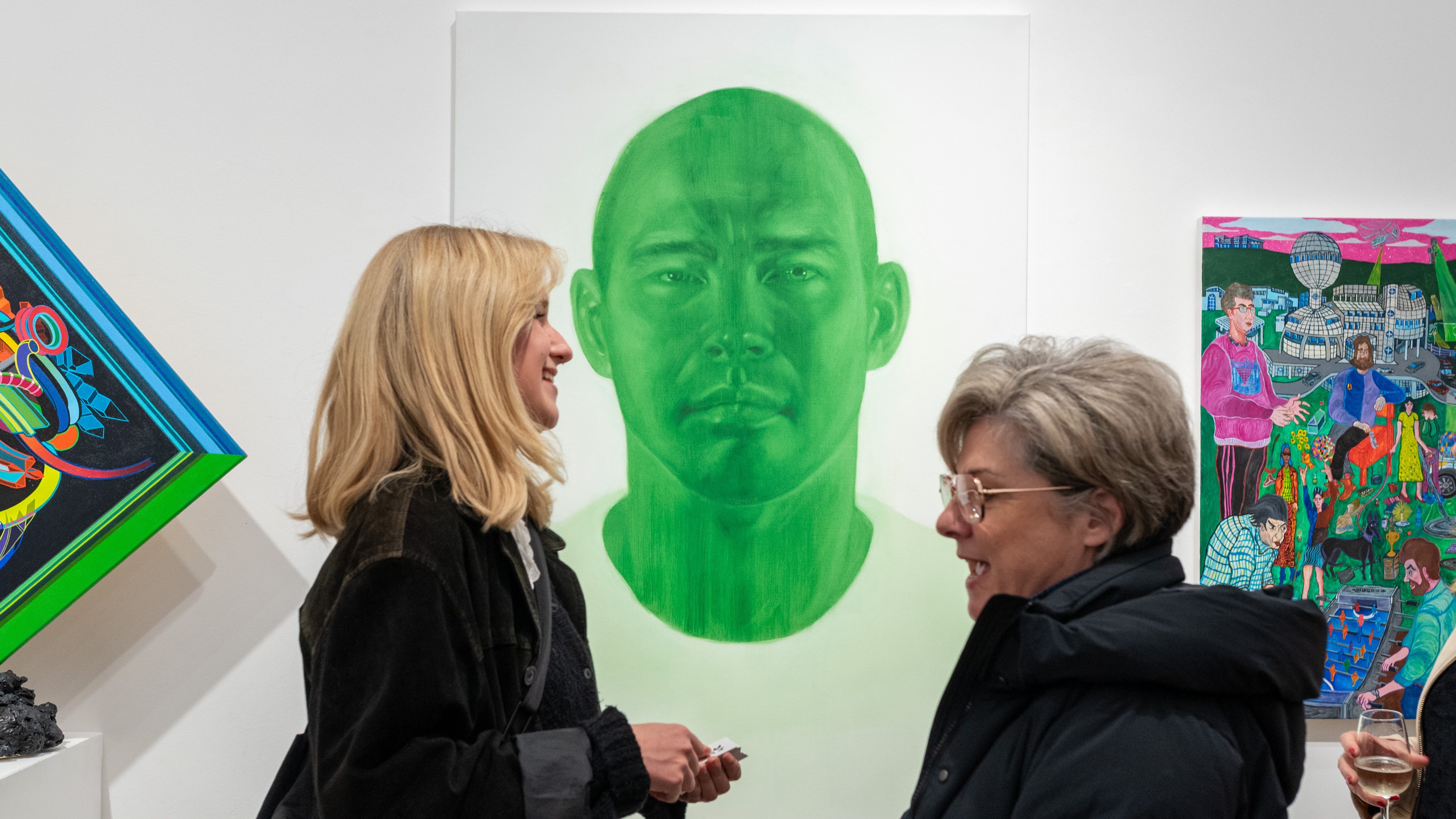 Women looking at Waverley Art Prize finalists' works at Bondi Pavilion Art Gallery, image by Lucy Parakahina.