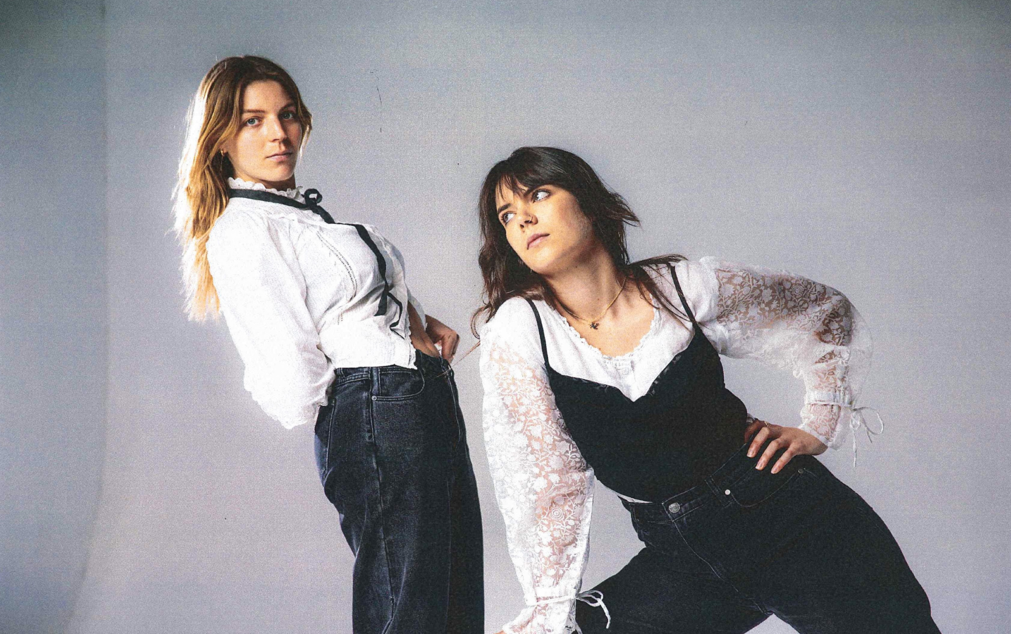 Two women musicians posing for a band photo