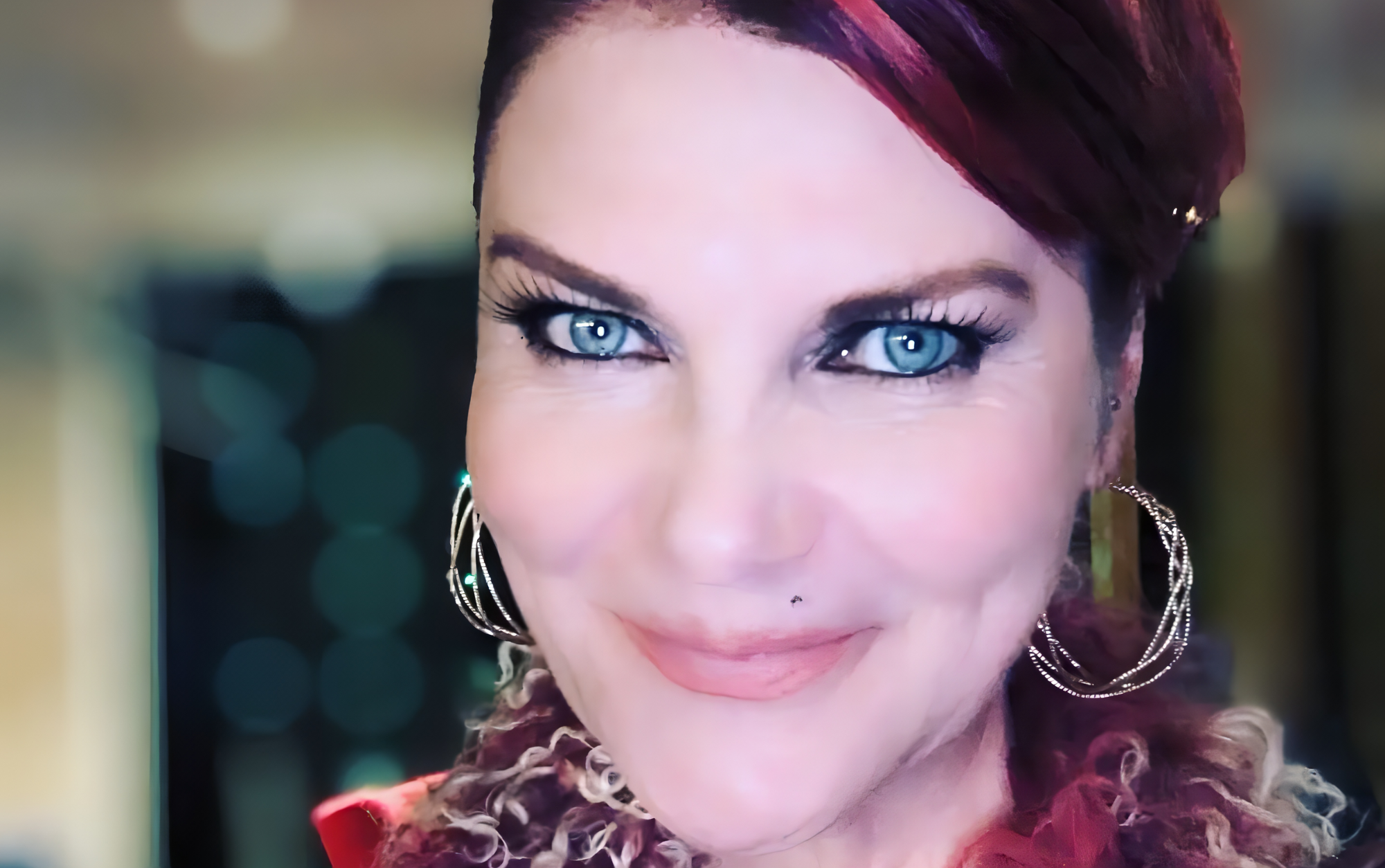 A woman with deep blue eyes looking into the camera