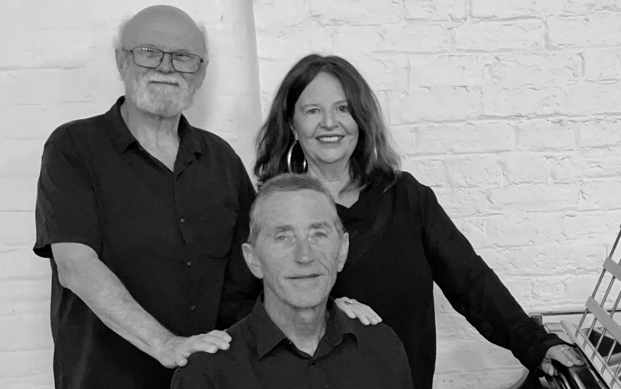 Three musicians dressed in black 
